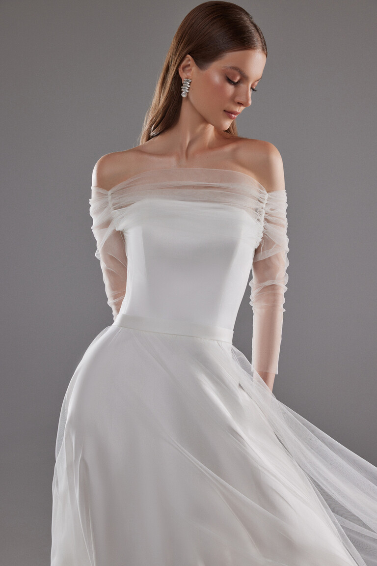 Close up of Millie off-white dress bodice with gathered sheer tulle off-shoulder neckline