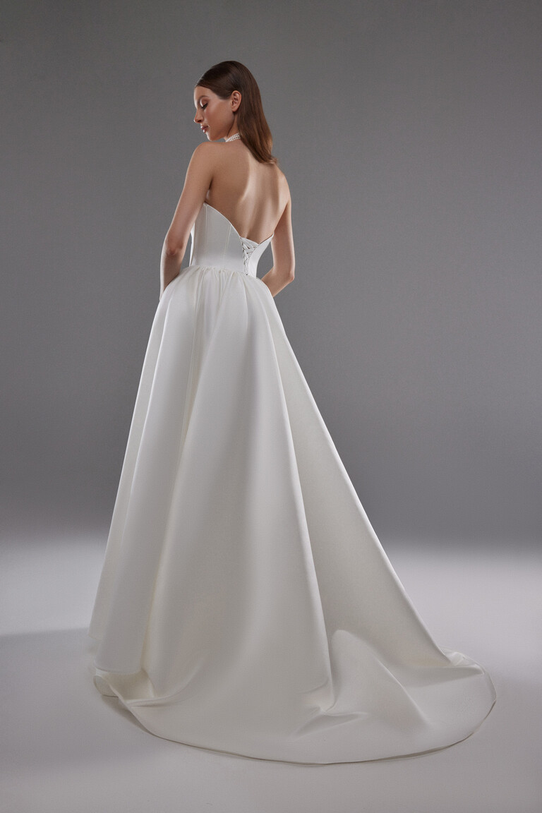 Elegant Lace Up Back and Train Detail Back view of Olvia satin wedding dress with lace up corset closure and long sweeping train