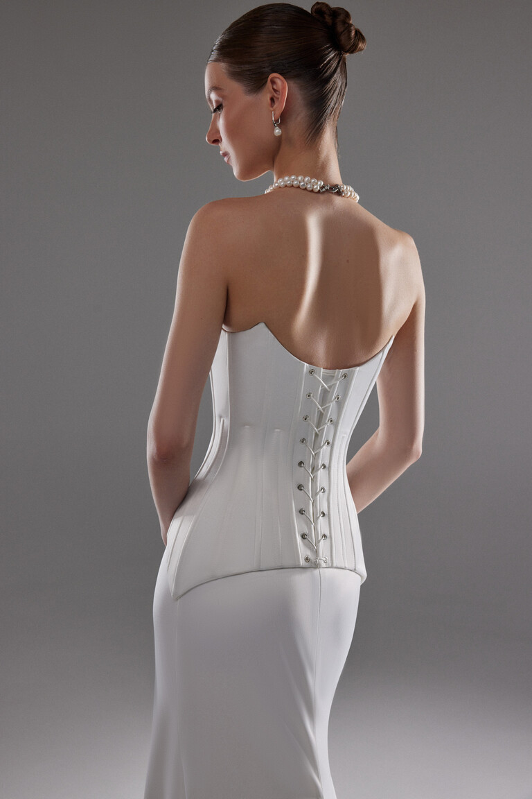 Detailed back view of Eliana gown featuring lace-up closure and exposed corset boning