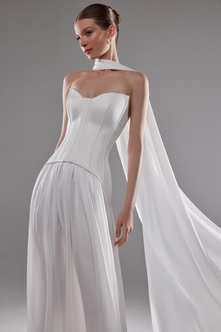 Unona Artemide dress styling with sheer trailing scarf and satin corset bodice texture