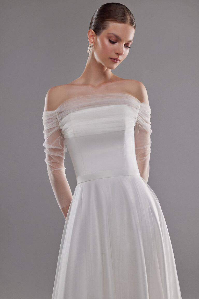 Close-up of Millie midi dress bodice showing sheer mesh drapery and pleated tulle sleeves in minimalist style