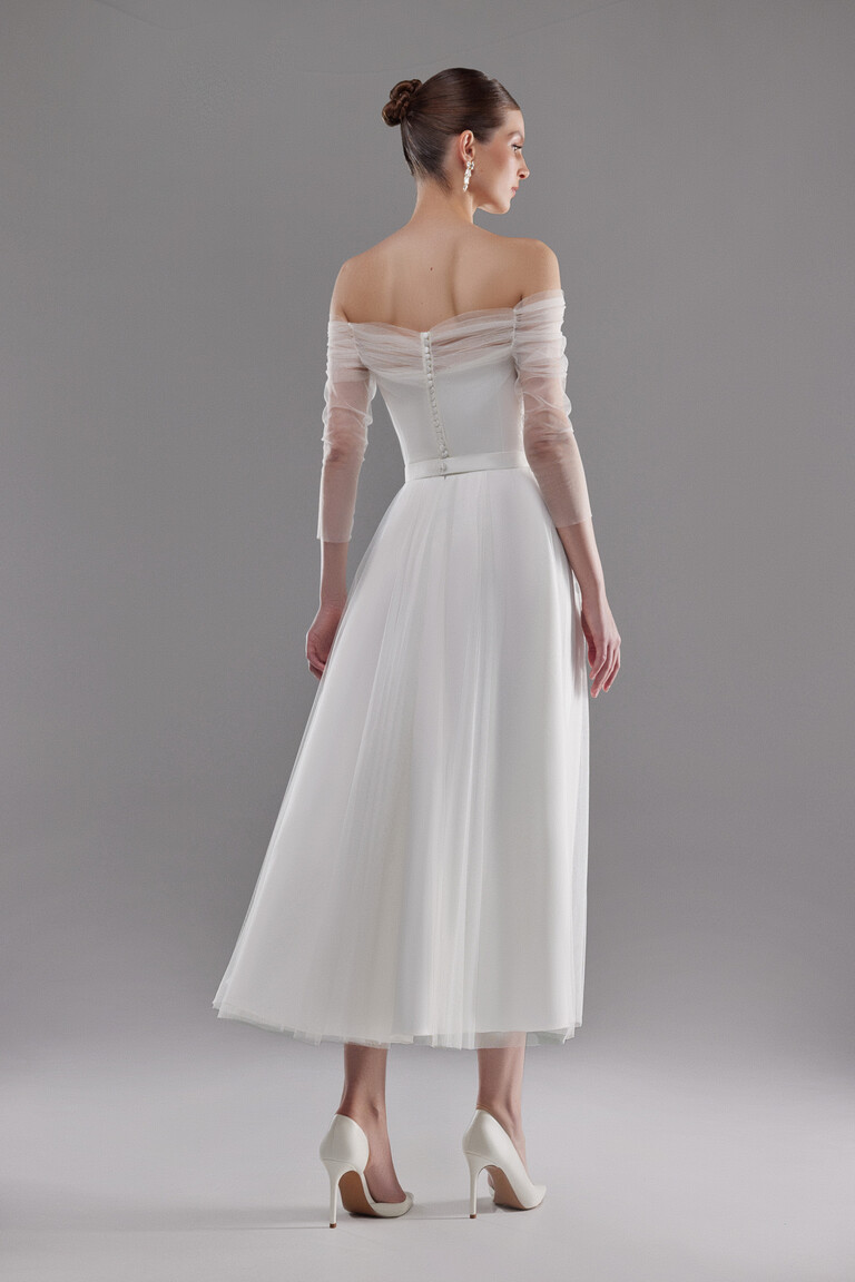 Back view of Millie midi bridal gown featuring a row of petite buttons and tea-length trapeze skirt in tulle