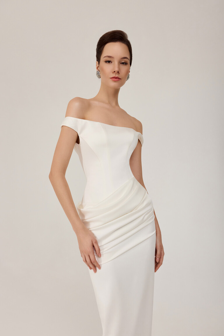 Close up of Kaira dress bodice showing corset structure and draped stretch satin hips in ivory