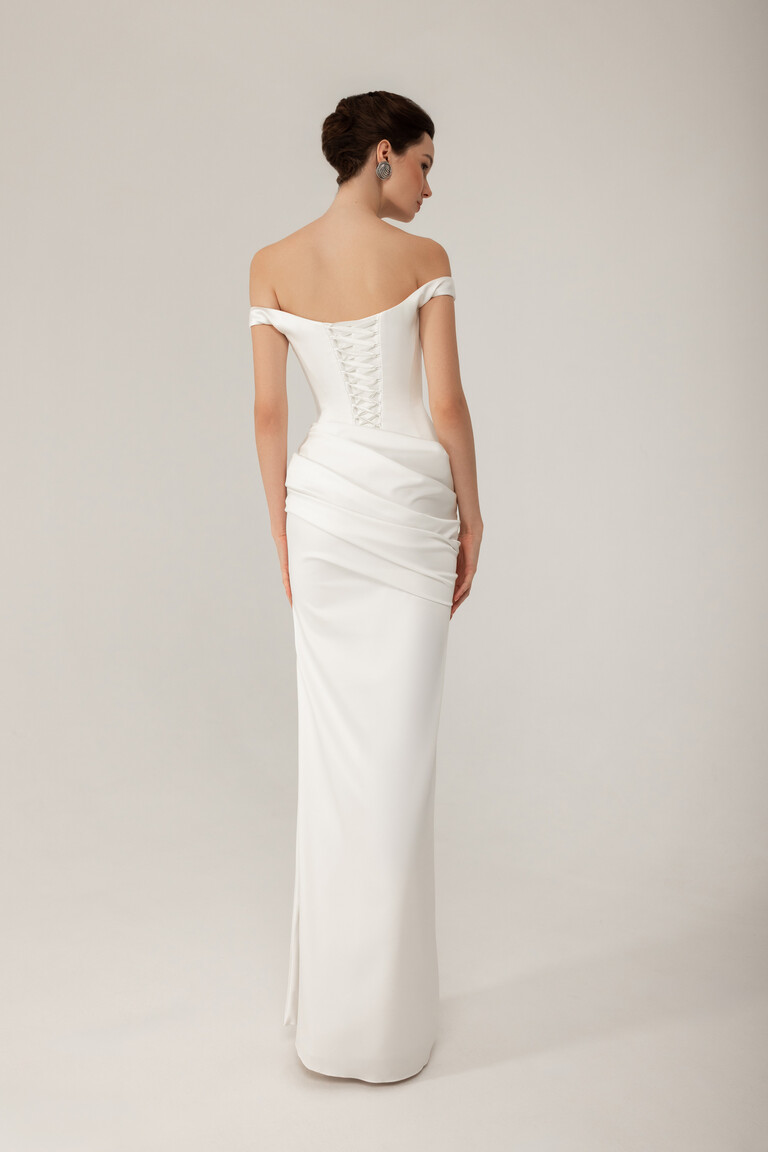 Full length back view of Kaira ivory off-shoulder gown with corset back and column skirt