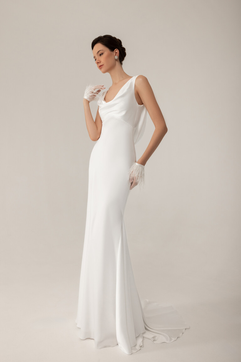 Three quarter view of Lea minimalist wedding dress highlighting cowl neck and smooth satin fabric