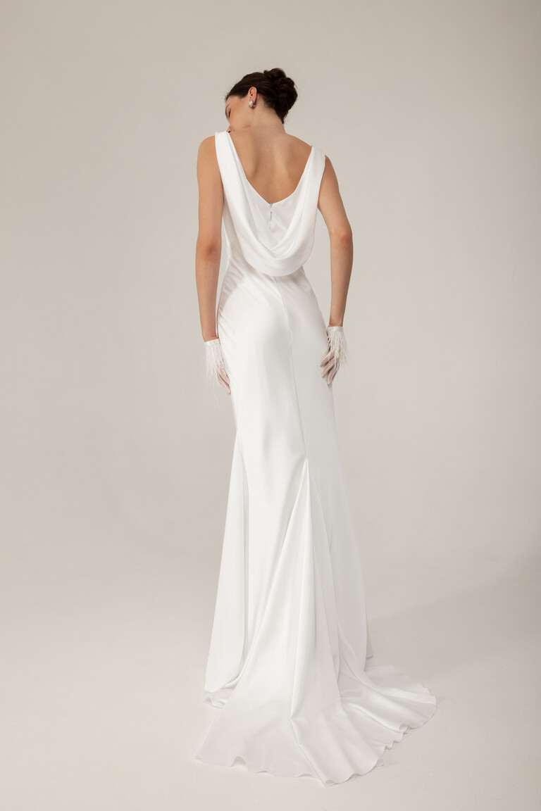 Rear silhouette of Lea mermaid wedding dress showing fitted hips and draped back detail