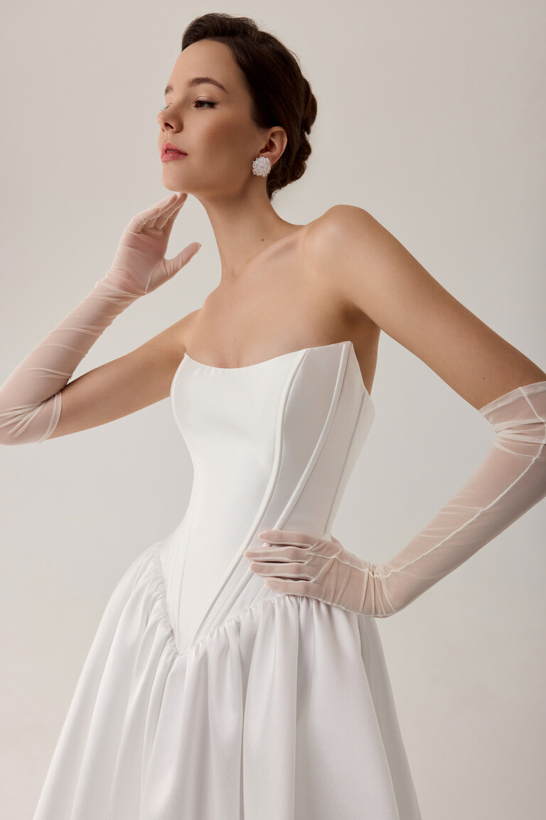 Faith bridal gown bodice close-up showing structured corset boning and pointed basque waist in Mikado
