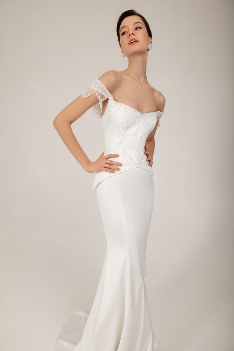Modern Structured Corset & Satin Skirt Diva modern bridal gown with structured lace corset and smooth satin skirt posed hands on hips