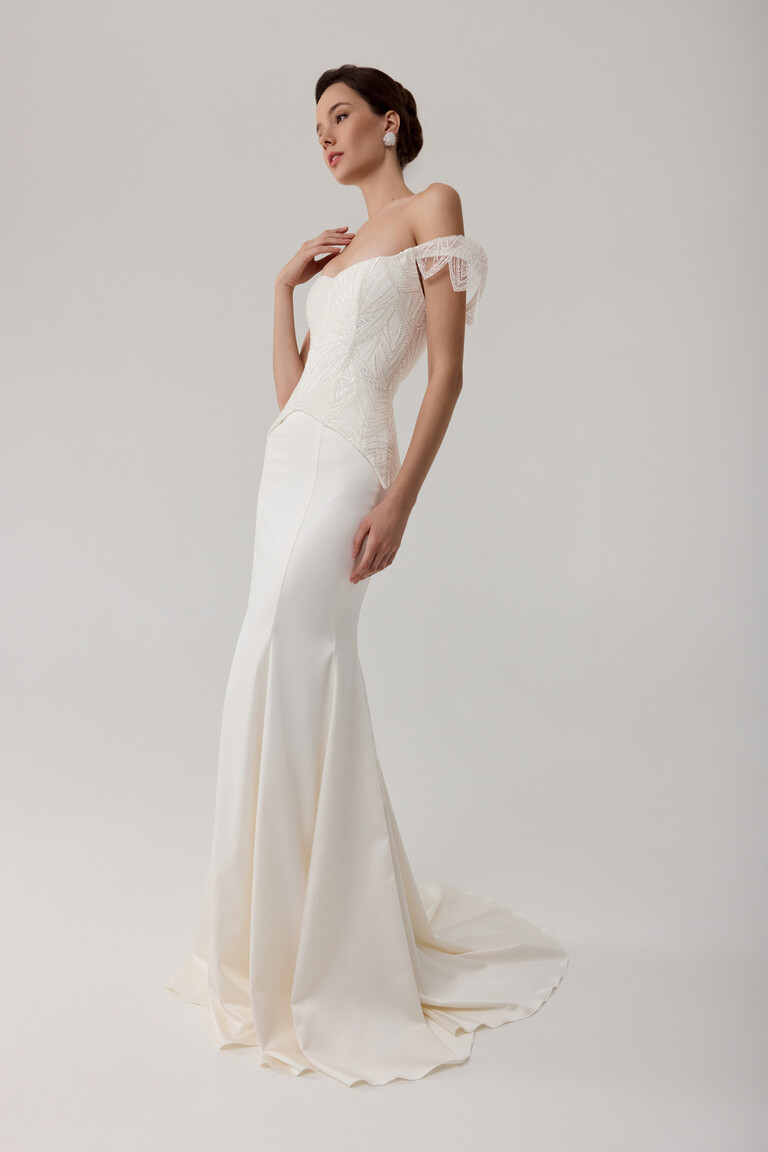 Elegant Beaded Bodice & Flare Skirt Diva off-shoulder wedding dress with geometric beaded bodice extending over hips in mermaid style