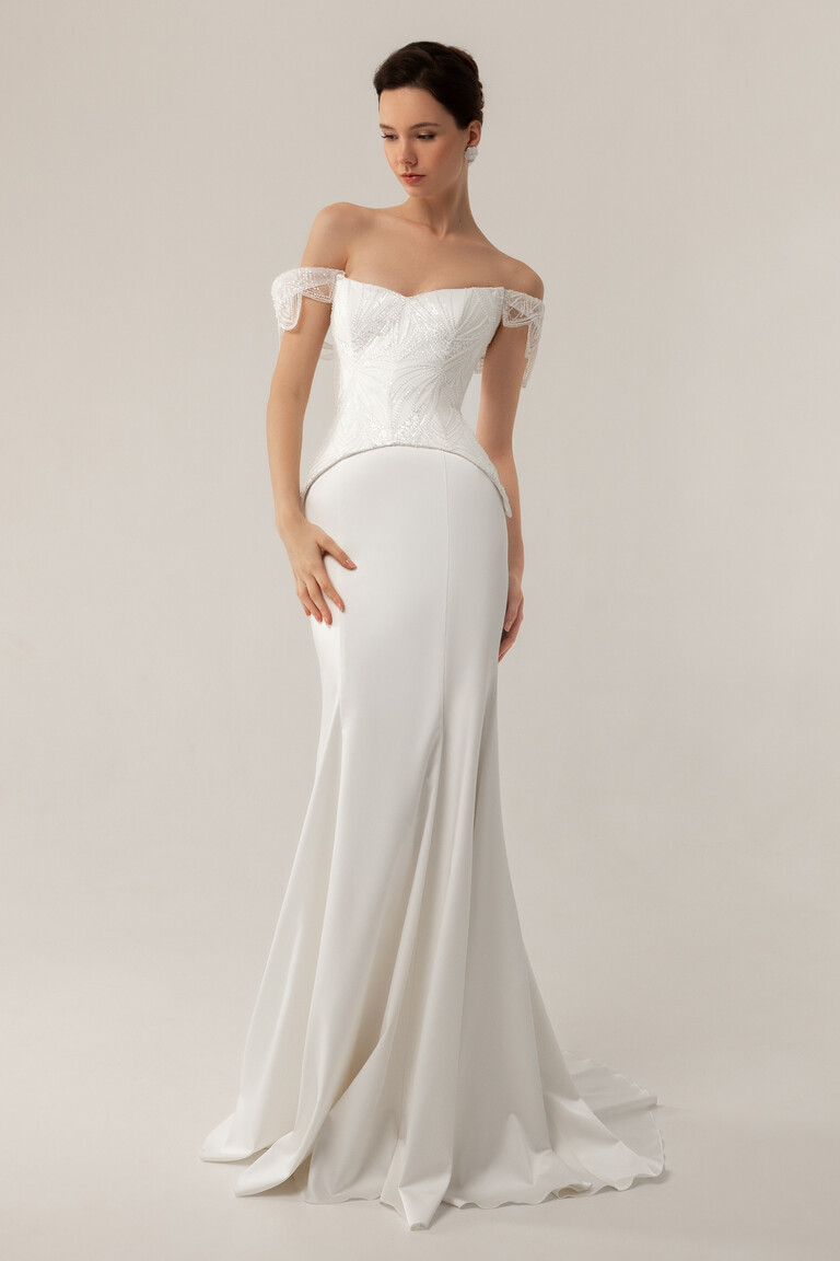 Diva Mermaid Wedding Dress Front View Full length front view of Diva off-white mermaid wedding dress with lace corset and satin skirt