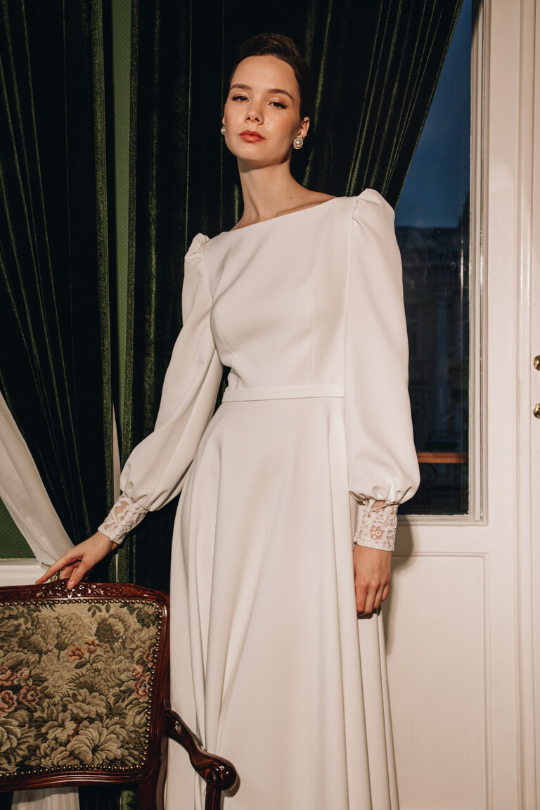 Camalia modest bridal gown featuring long bishop sleeves with puffed shoulders and lace cuffs