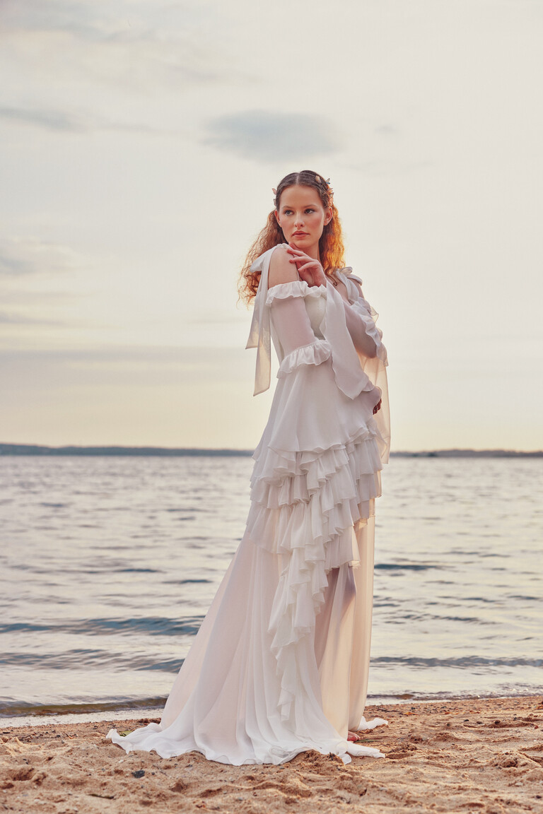 Riot flowy wedding dress with billowy sleeves and asymmetrical ruffles for destination weddings