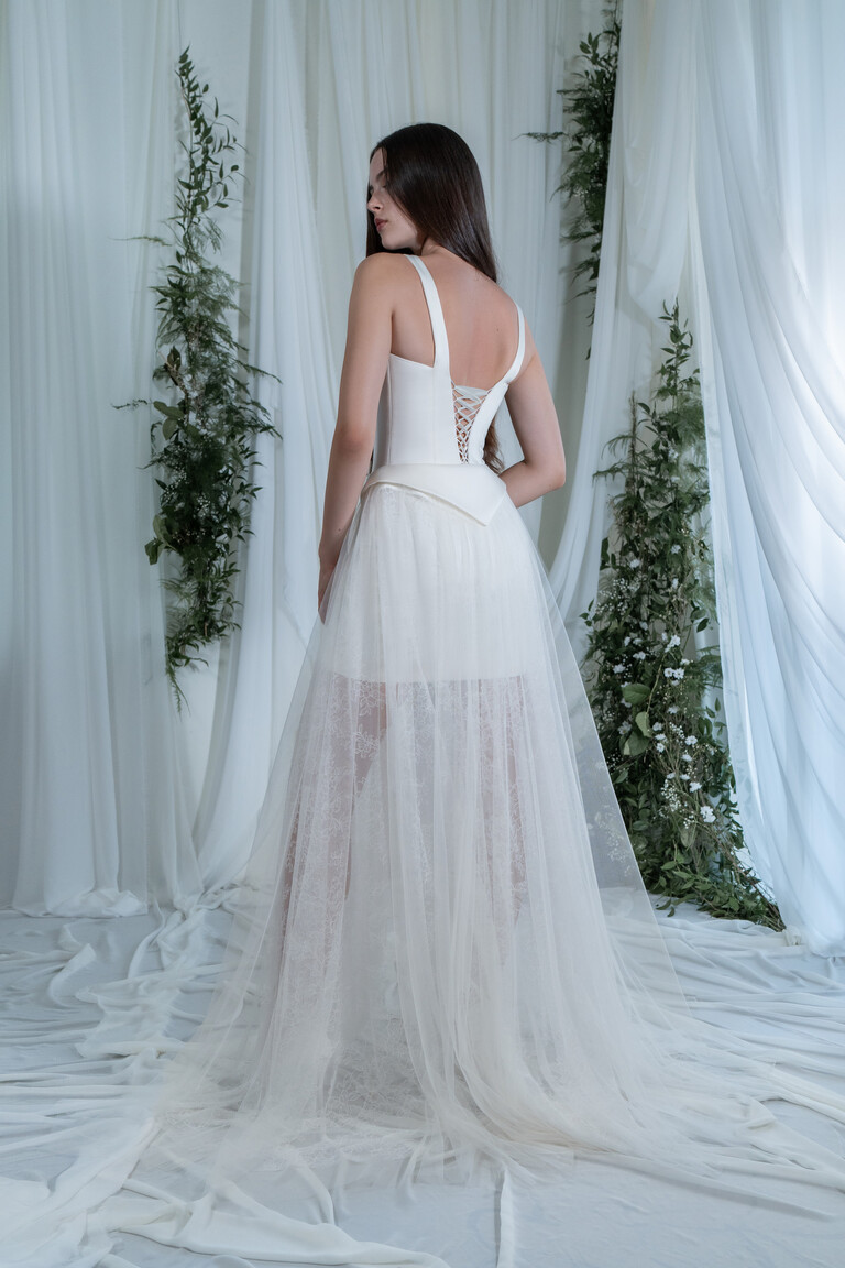Full back view of Emily off-white dress with corset lace-up closure and floor length mesh overskirt