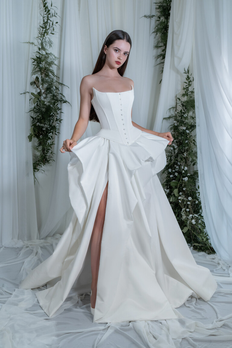 Sonara off-white taffeta wedding dress front view featuring a strapless corset bodice with buttons and a high thigh slit