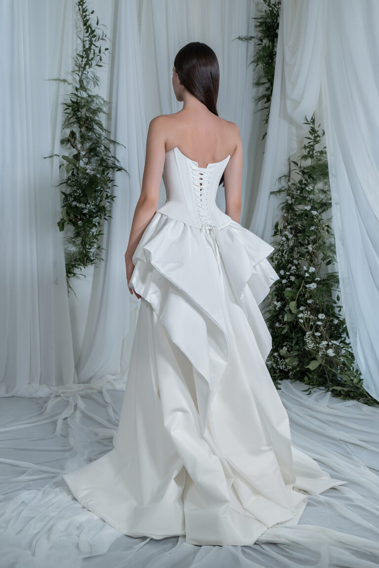 Back view of Sonara taffeta gown featuring a secure lace-up corset closure and cascading ruffles extending into a train