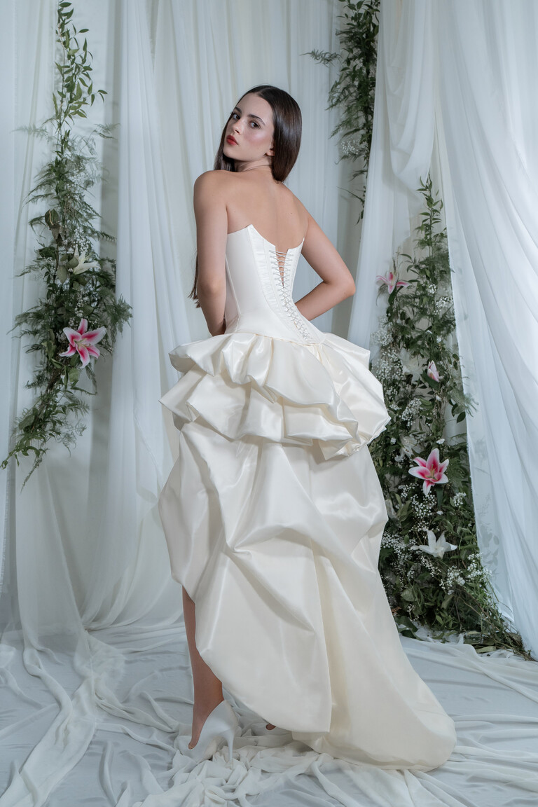 Back view of Unona Amira wedding dress with lace-up corset and long Champagne taffeta train