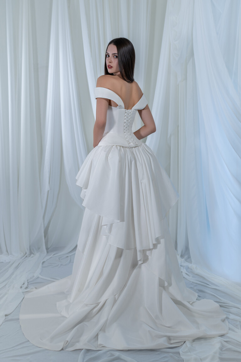Paradise wedding dress back view featuring lace-up corset closure and long sweeping taffeta train