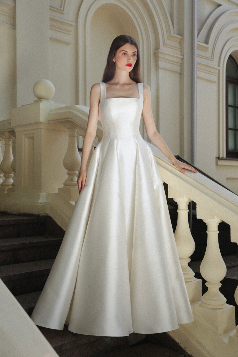 Modern minimalist Jolie wedding gown in off-white Mikado fabric showing fitted bodice and full A-line skirt