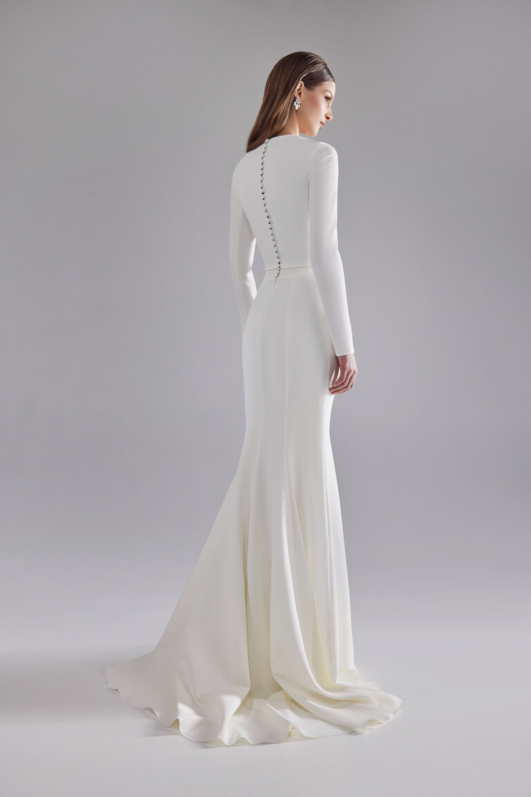 Back view of Arlette wedding dress featuring row of covered buttons and soft sweep train
