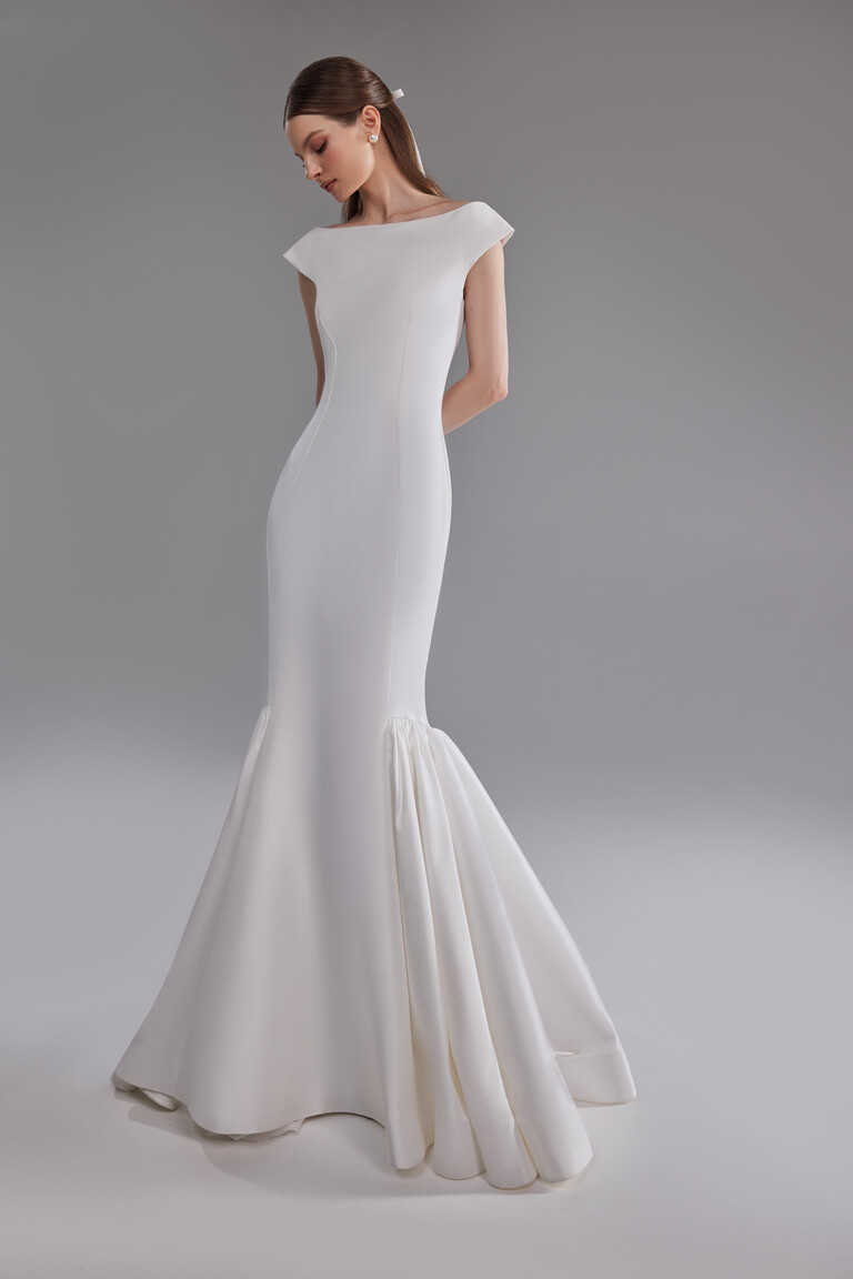 Three-quarter view of Rachel fitted mermaid bridal gown in off-white mikado fabric