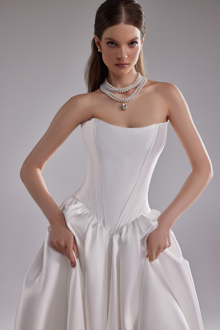 Faith off-white corset dress front view with pearl accessories