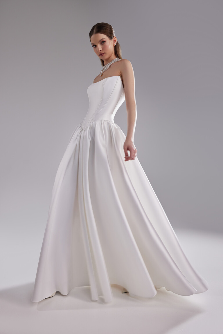 Faith floor-length bridal gown with dropped basque waist and pleated skirt