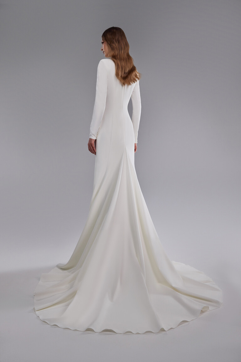 Rear view of Odetta fit and flare wedding dress showing vertical seams and sleeve buttons