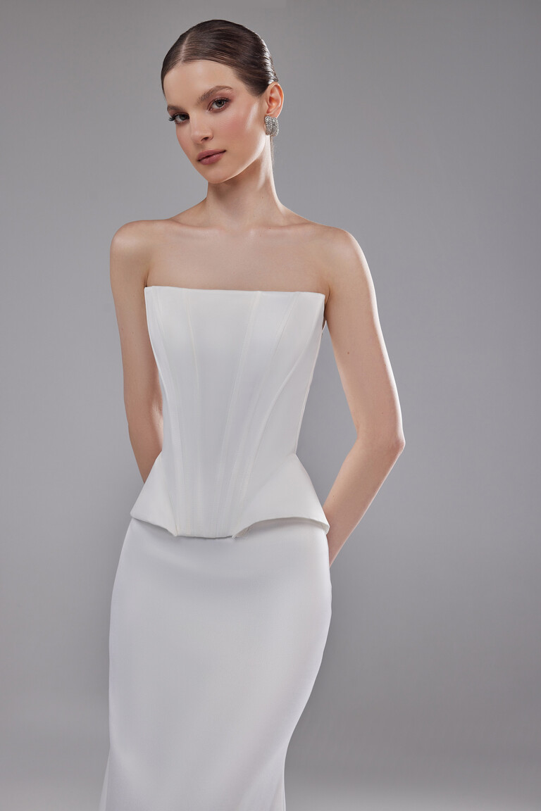 Front view Hazel strapless satin corset top with peplum waist and fitted skirt