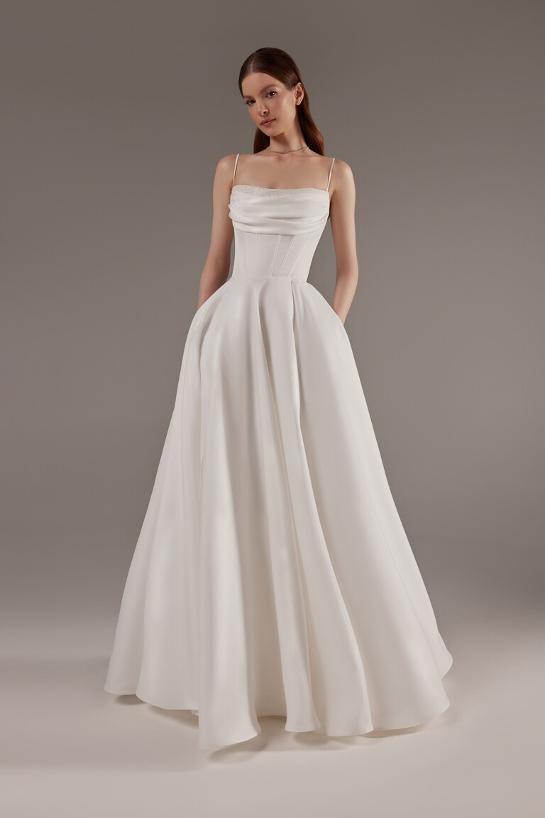 Elegant A-Line Silhouette with Structured Corset Bodice Full length view of Rihanna ivory satin A-line bridal gown with corset bodice and spaghetti straps