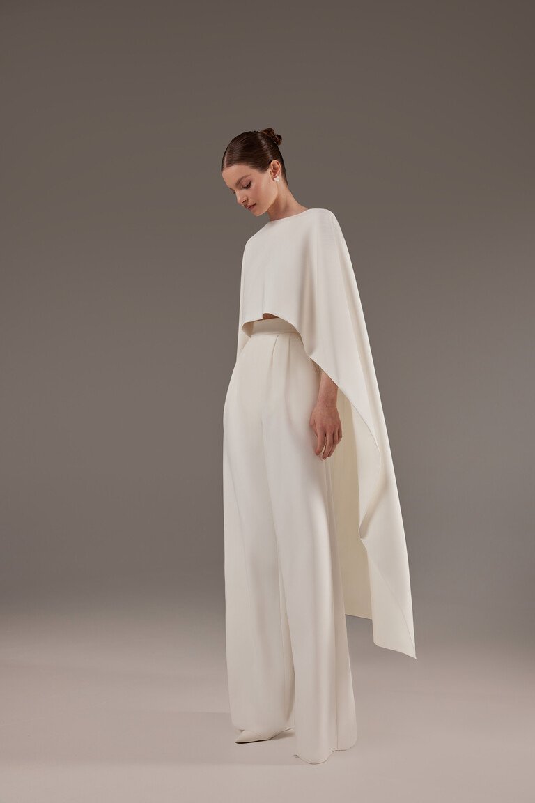 Side view of Cape Gera ivory crepe bridal cape showing floor length drape and modern architectural silhouette