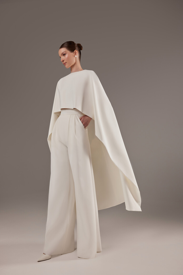 Unona Cape Gera ivory bridal cape offering elegant arm coverage and flowing silhouette for modern brides