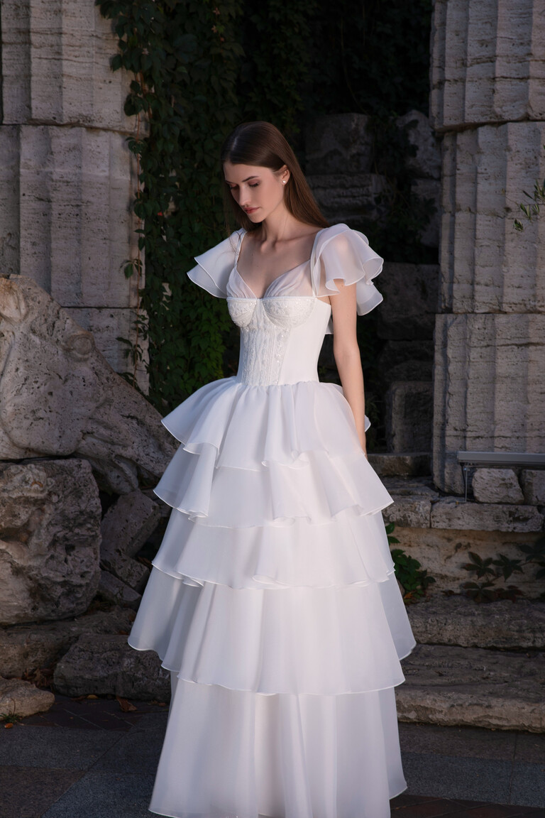 Front view of Cvit A-line wedding gown showing sweetheart corset and sheer organza flutter sleeves