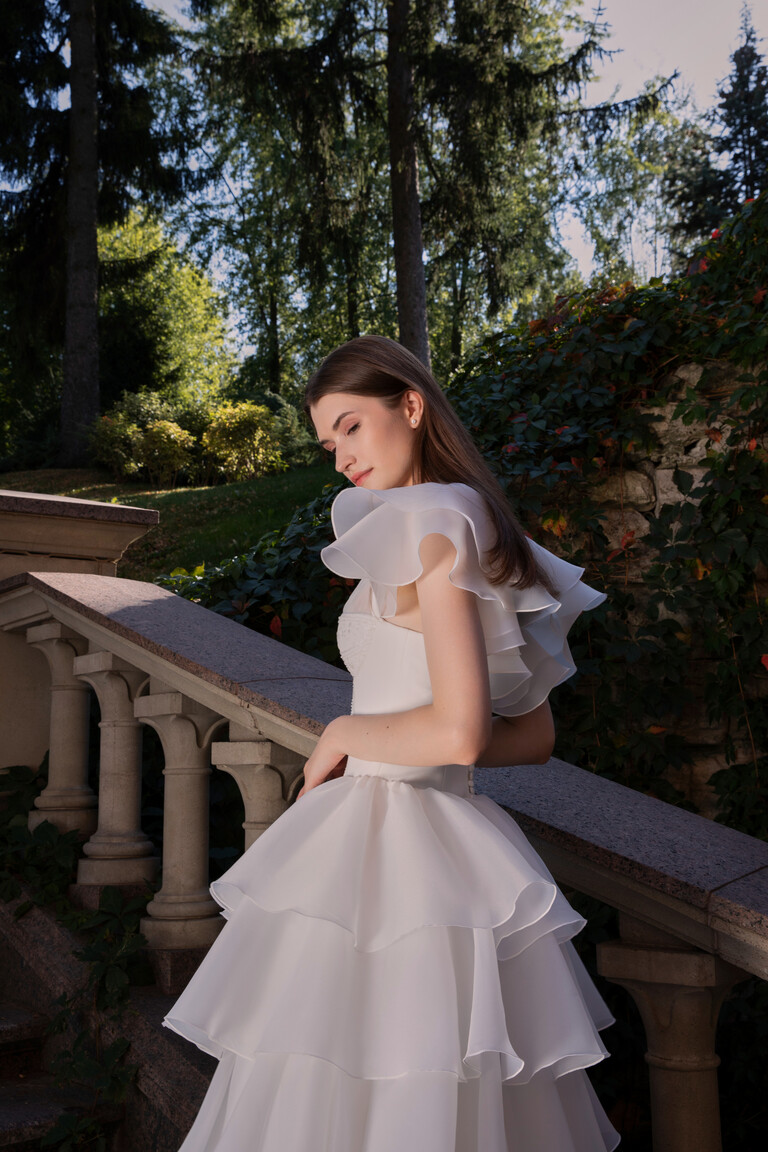 Side profile of Cvit couture bridal gown highlighting architectural volume and tiered organza ruffles