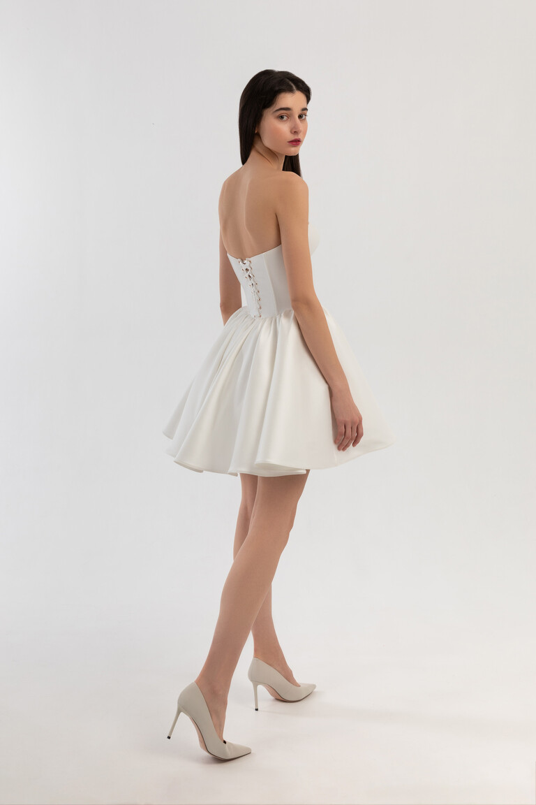 Back view of Cami short Mikado dress showing lace-up corset and flared A-line skirt in off-white