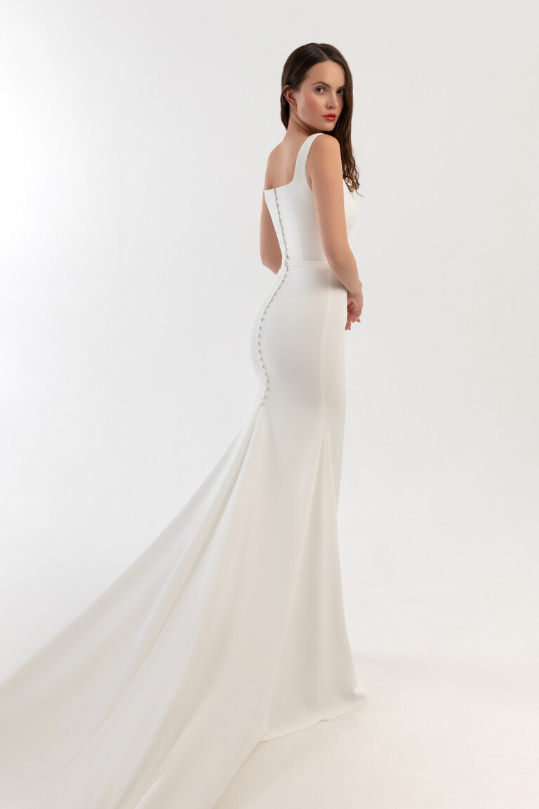 Back view of Justina mermaid wedding dress with row of buttons and elongated train