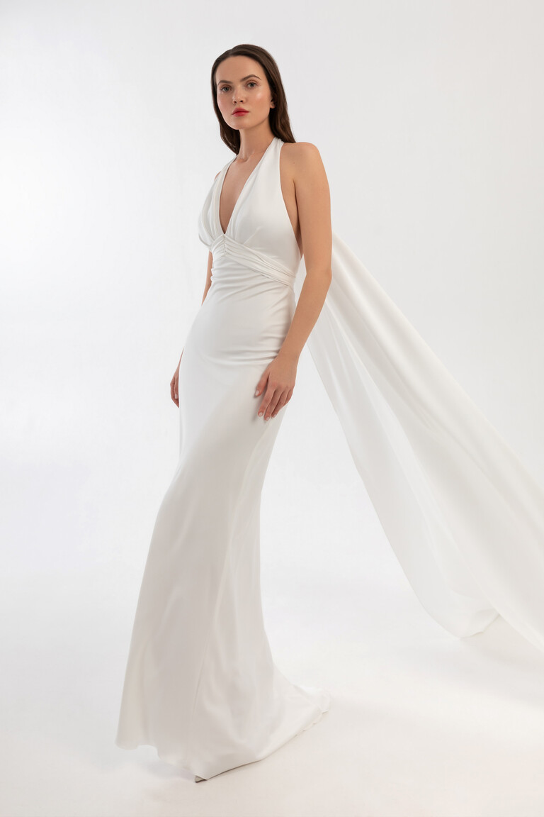 Athena silk wedding dress with shawl draped from shoulders creating a dramatic flowing cape effect