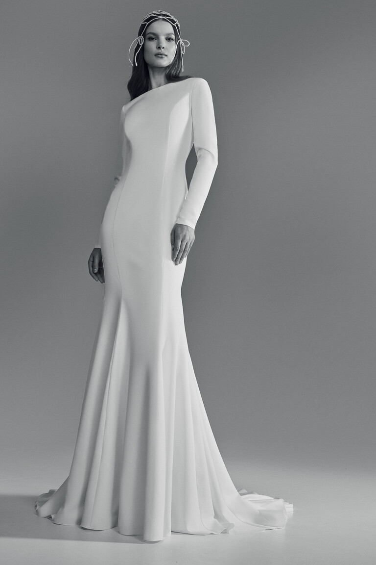 Unona Odetta fit and flare wedding dress front-side view with sweep train