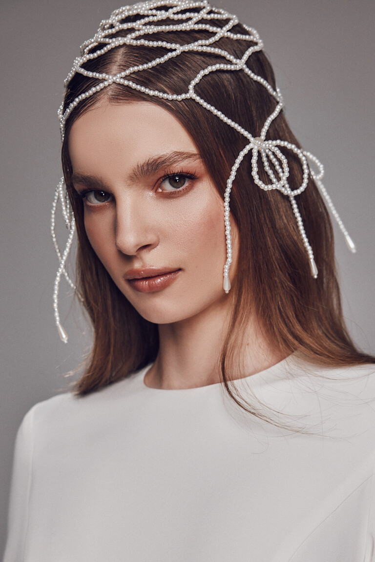 Close-up of lattice pearl headpiece styled with Odetta high neck wedding dress