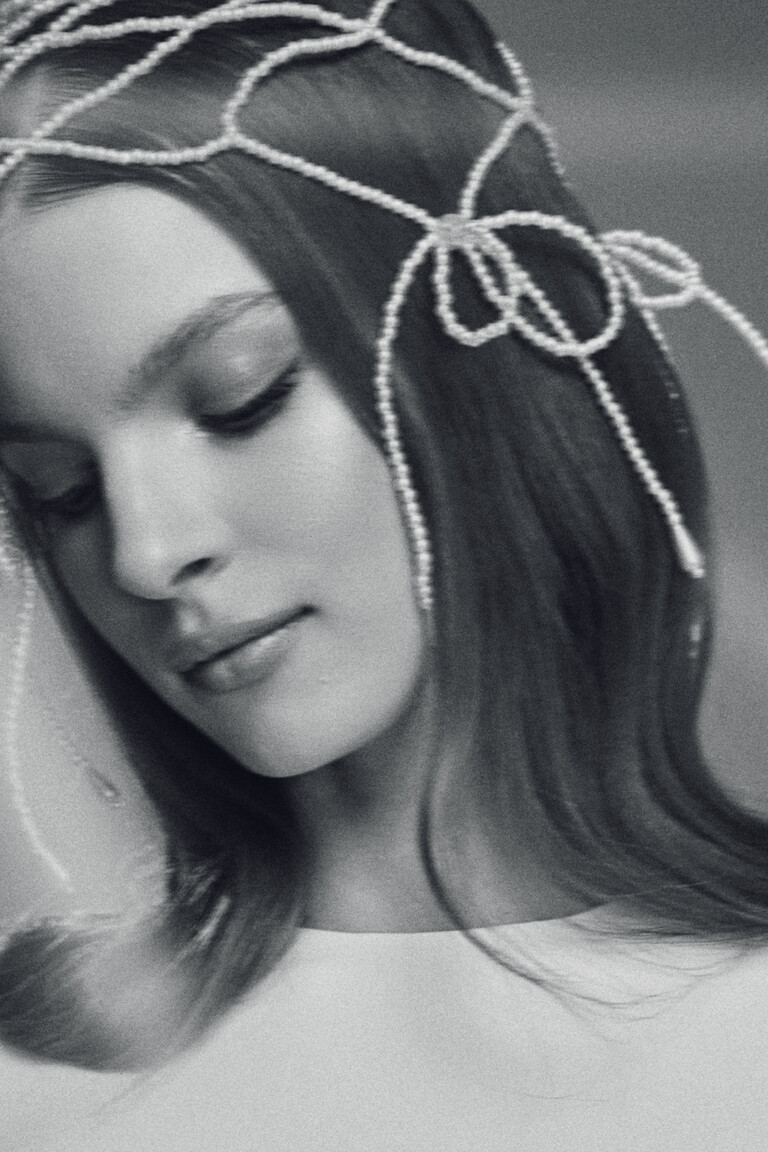 Close-up B&W detail of pearl headpiece styled with Odetta minimalist wedding dress
