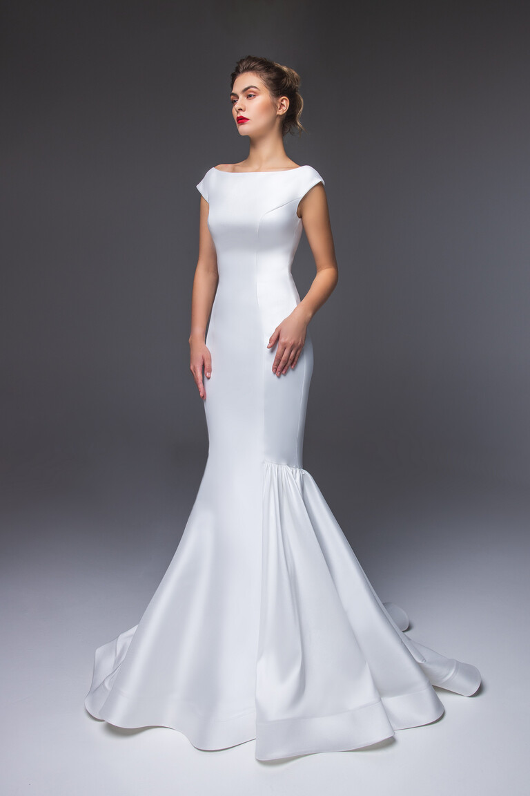 Rachel trumpet wedding dress three-quarter view showing skirt flare and clean lines