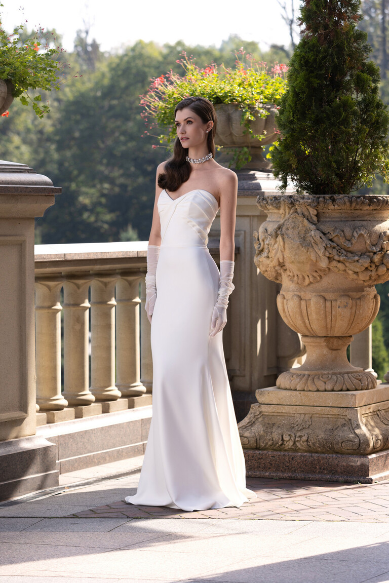 Semi-profile view of Blair stretch crepe bridal gown by Unona showing fitted mermaid silhouette and draped bodice