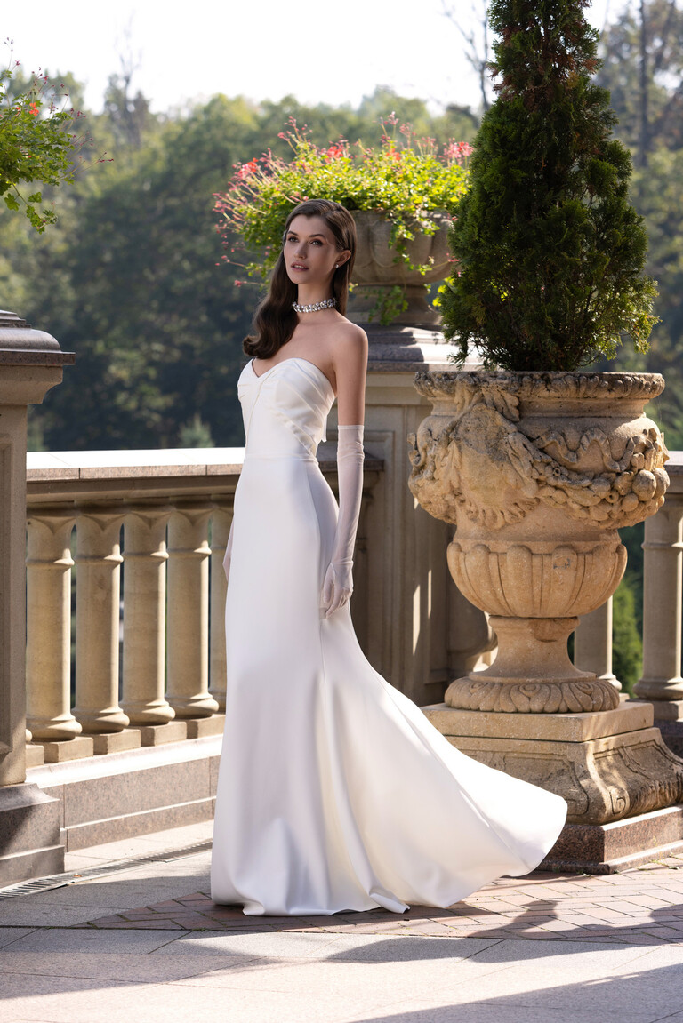Full length Blair trumpet wedding dress in off-white crepe featuring a figure-hugging bodice and flared skirt