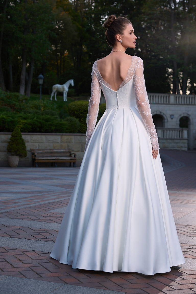 Full back view of Quinn off-white satin wedding dress with long lace sleeves and train