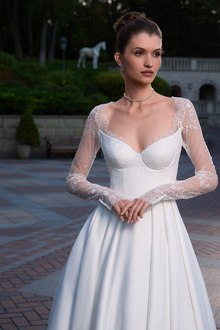 Close up of Quinn dress sweetheart neckline and Chantilly lace long sleeves with buttons