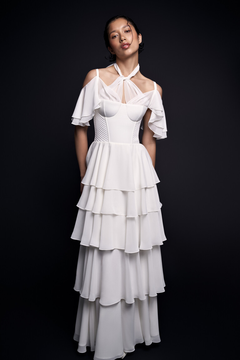 Sia off-white bridal gown front view showing structured corset bodice and layered sleeves