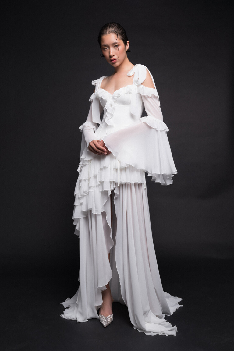 Riot off-white chiffon wedding dress front view with corset bodice and ruffled skirt slit