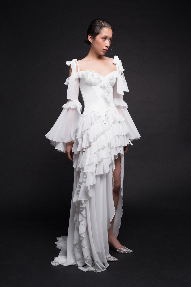Riot boho bridal gown featuring tiered chiffon ruffles and structured corset bodice details