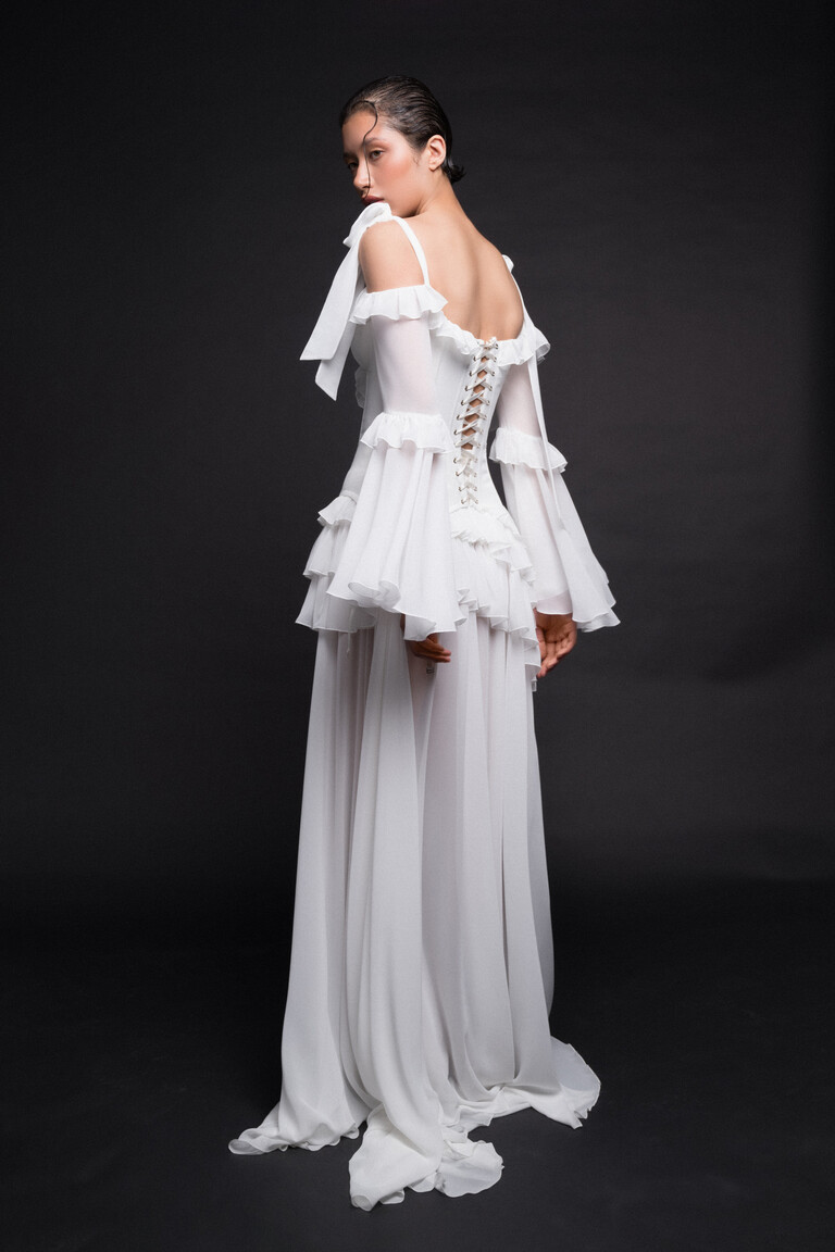 Back view of Riot wedding dress showing lace-up corset and long sheer bell sleeves