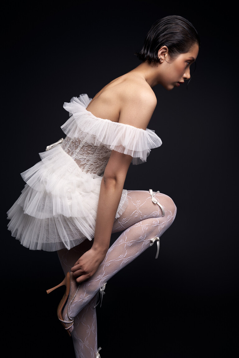 Side profile of Luna off-the-shoulder mini dress with tiered ruffled tulle layers