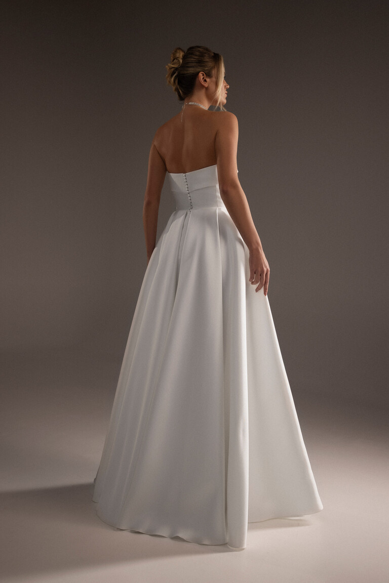 Back view of Sophie ivory Mikado gown showing vertical covered buttons and A-line silhouette